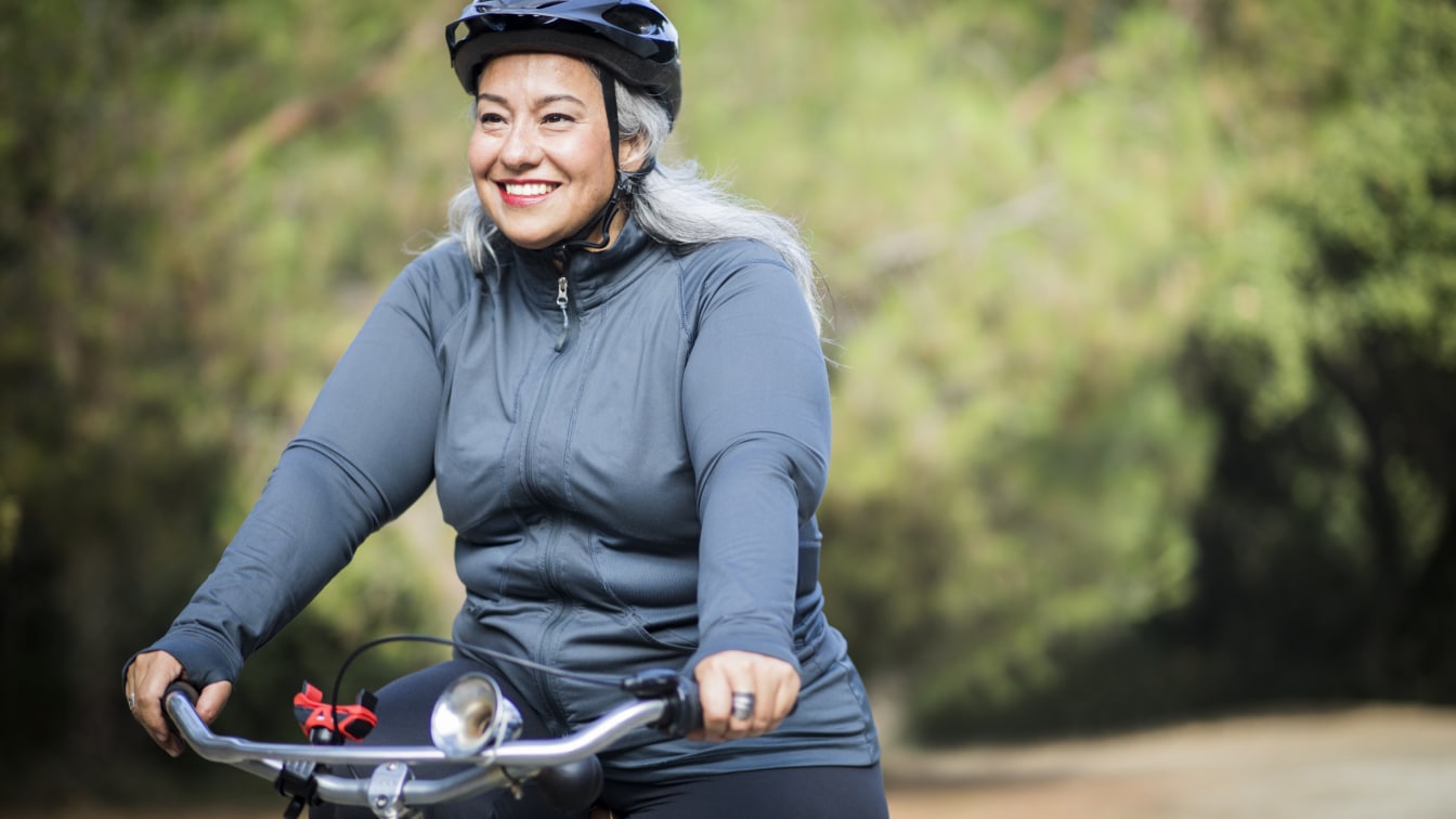 Our Impact woman riding bike