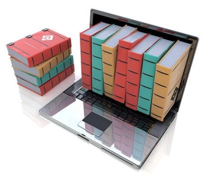 Photo of books coming out of a laptop screen.