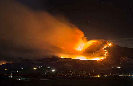 Wildfire burning on the side of a large hill at night. Wildfire burning on the side of a large hill at night.