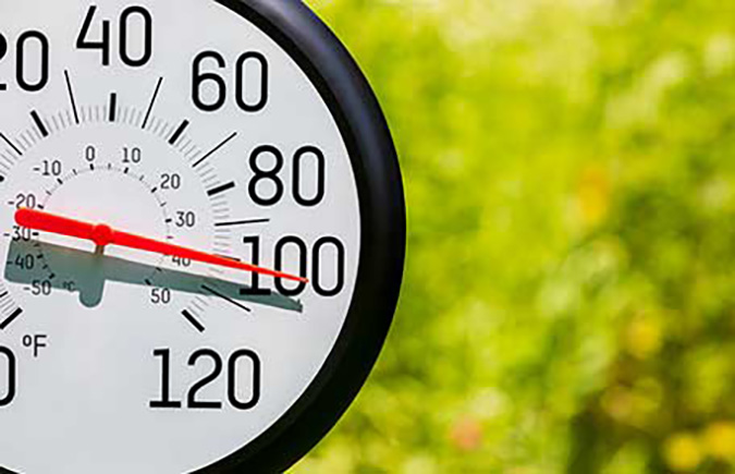 An outdoor thermometer reading a temperature above 100 degrees Fahrenheit.