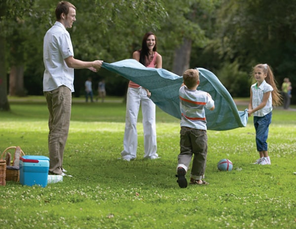 Family preparing to have a picnic in a city park
