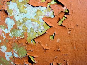 chipped lead paint Image of peeling paint on a wall.