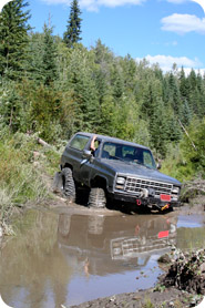 An off-road vehicle bogged down in mud