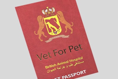 Cropped image of a red passport book an official-looking emblem featuring pets and a crown 
