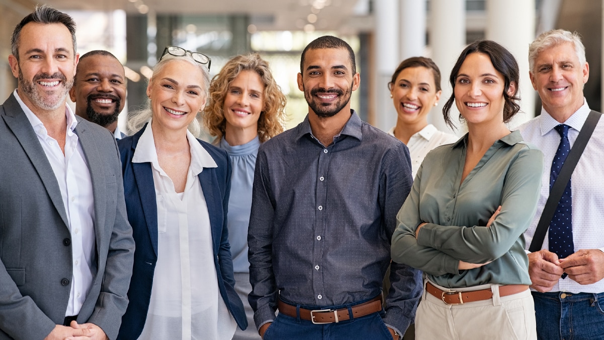 Workforce Diversity Portrait of successful group of businesspeople at modern office looking at camera.