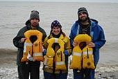 paul_revere_crew The three crew members of the setnet skiff Paul Revere posing on the shore of Bristol Bay, Alaska with the inflatable personal flotation devices that saved their lives.