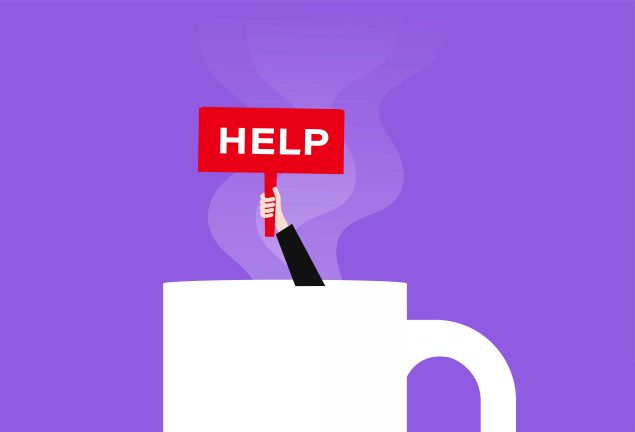 GettyImages-1294089406 Converted 2_ coffee mug with arm extending out holding sign which reads help