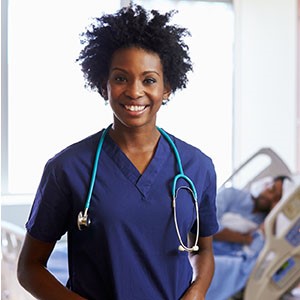 nurse Nurse standing in patient room with patient in the background.