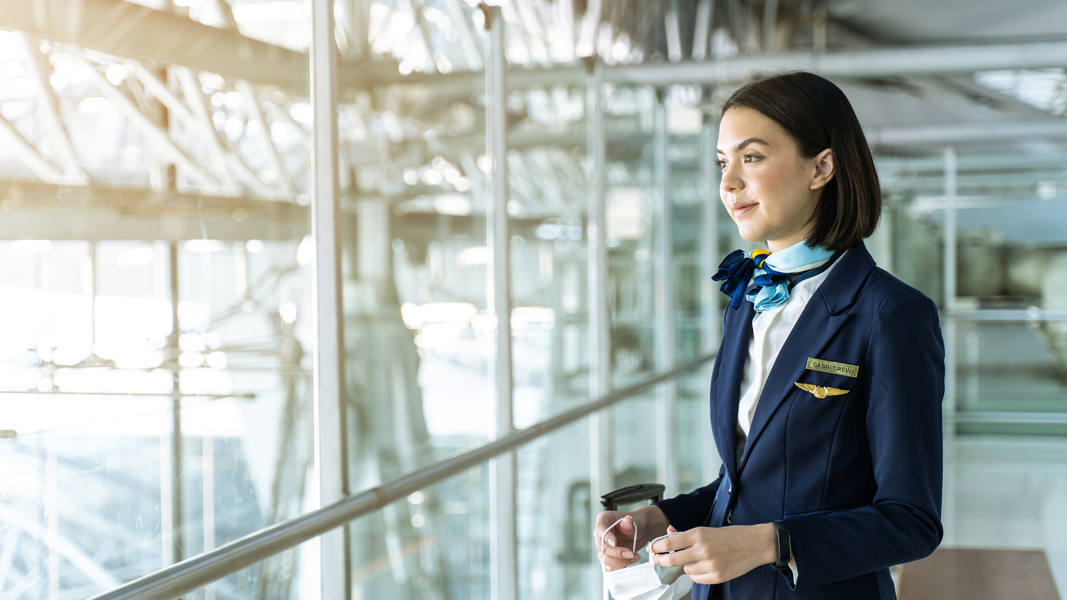 1312141732 Female aircrew member between flights in an airport.
