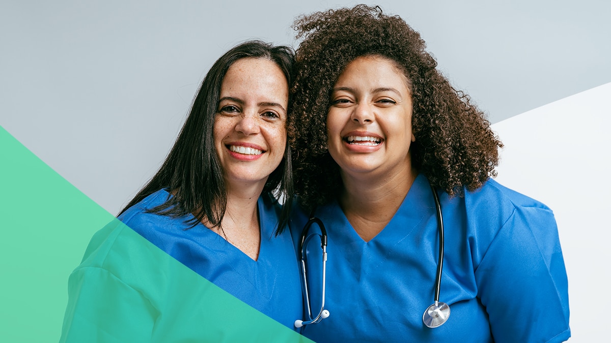Campaign Insights Image 2 Two healthcare workers pose together with big smiles.