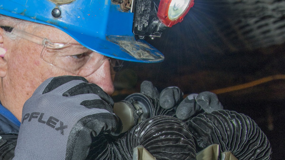 Miner breathing through respirator