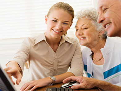 A woman helping a couple find information on the Intranet