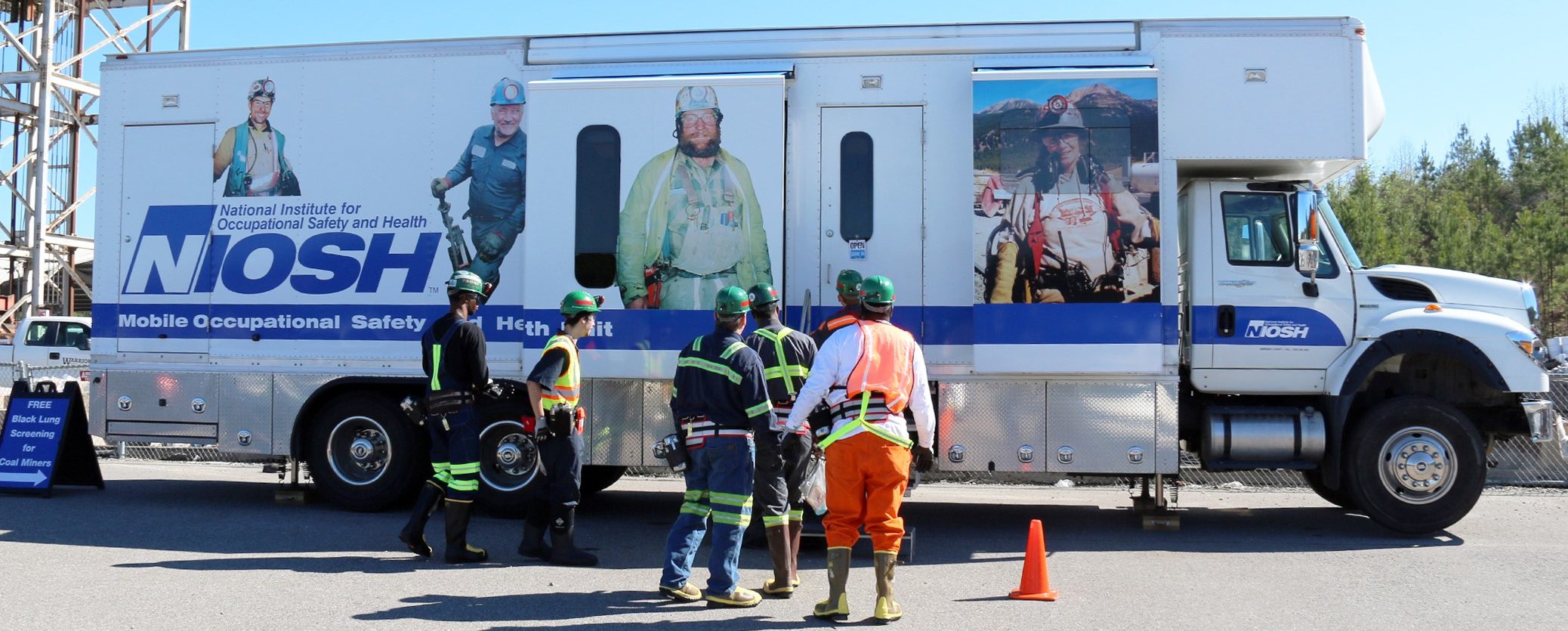 Mobile screening van with line of people out front