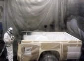 isospot2.jpg worker spraying truck bed