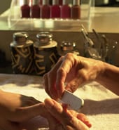 manicurethumb.jpg Hand shot of a manicurist filing a customer’s fingernails