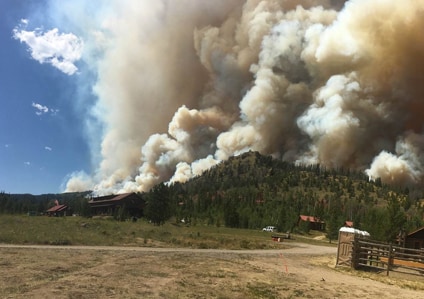 Smoke emanating from a forested hill