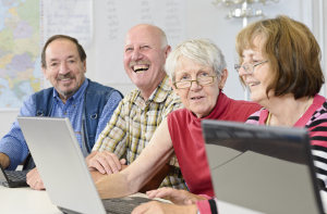 Research Goals a group of workers gathered around a couple laptops