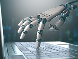 Research robot typing on a laptop computer