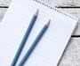 Two pencils on a pad of paper