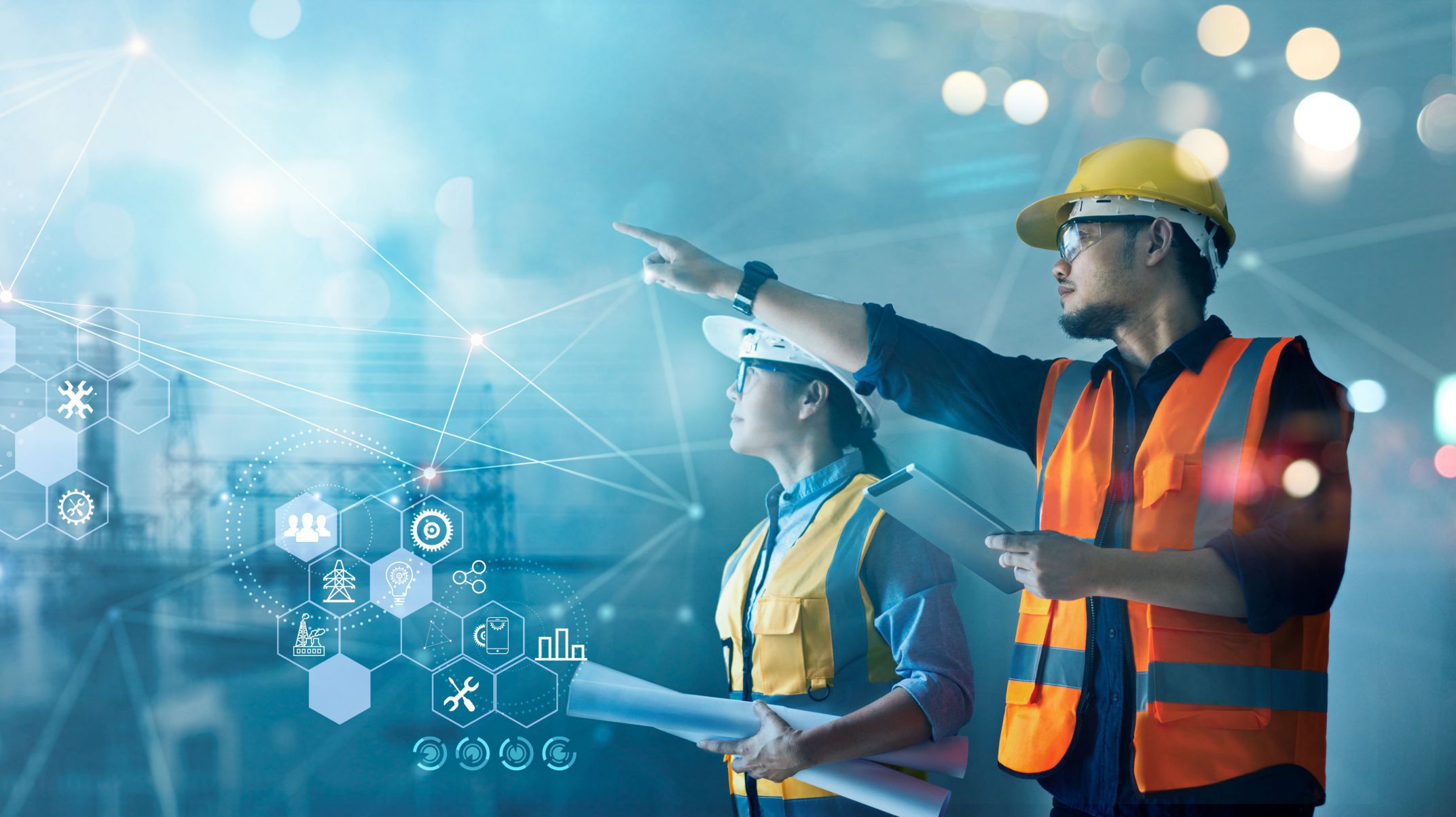 Male and female industrial engineers using tablet computer and blueprints checking and analysis data of power plant station project on network background. Male and female industrial engineers using tablet computer and blueprints checking and analysis data of power plant station project on network background.