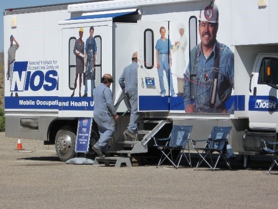 Miners entering a mobile screening vehicle Miners entering a mobile screening vehicle