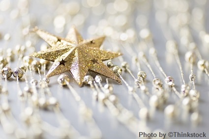 M10G A golden glittered star ornament with smaller surrounding ornaments