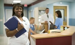 HealthyWorkDesign.jpg A nurse in a hospital smiles at the camera
