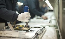 musculoskeletal.jpg An assembly line, with the focus on an individual screwing in a computer part.