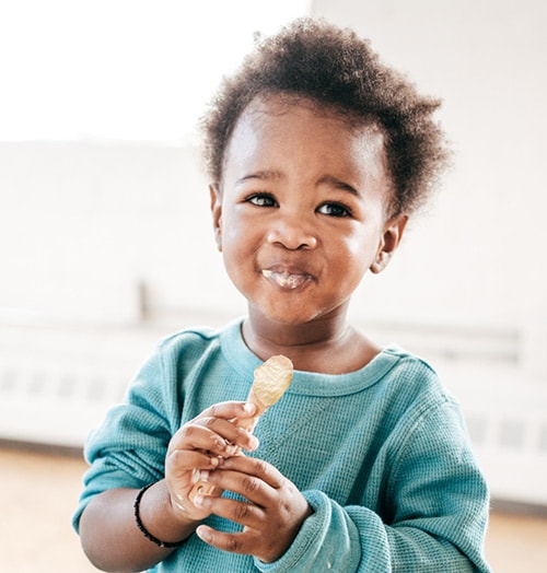 6-to-24-months A young child to eating from a spoon.