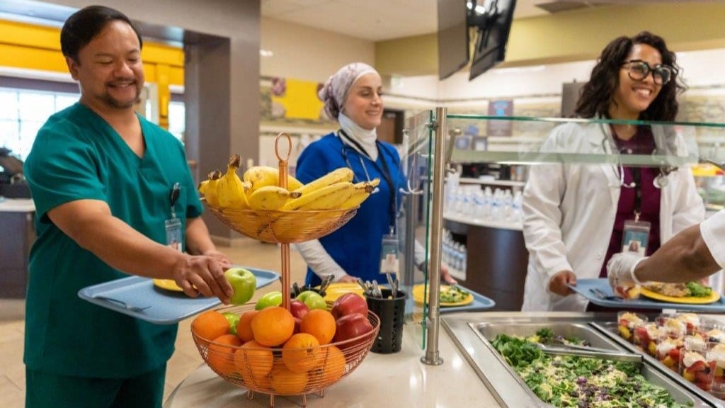 — title missing — Medical staff choosing healthy options in serving line of hospital cafeteria.