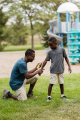 nookatook Parent applying insect repellent to a child.