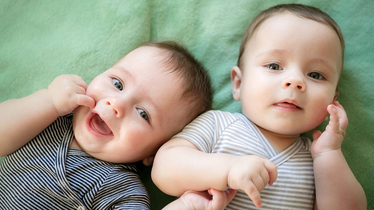 Twin boys Newborn twins boys are lying on the bed