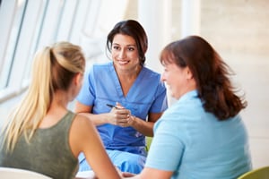 pediatrician teen parent Photo of a pediatrician talking to a parent and teenager
