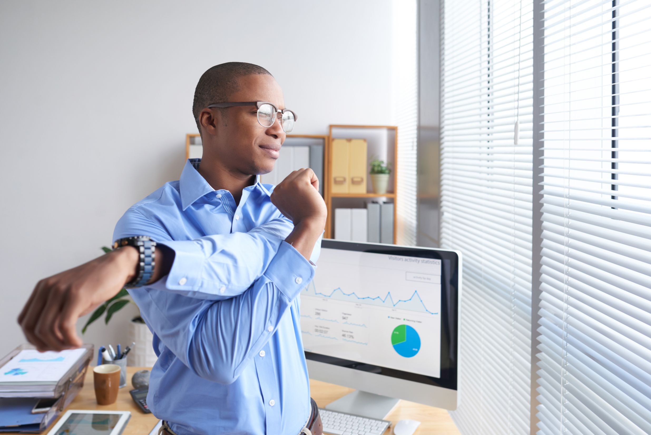 Man stretching at office
