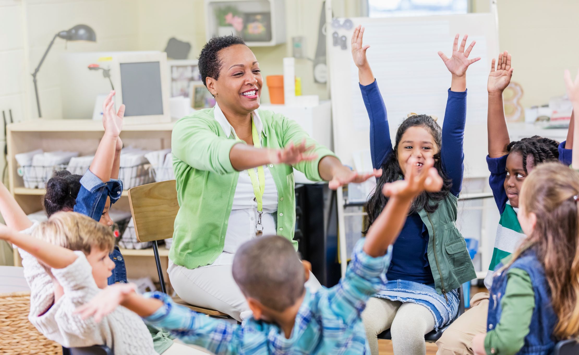Woman Teacher with young children students