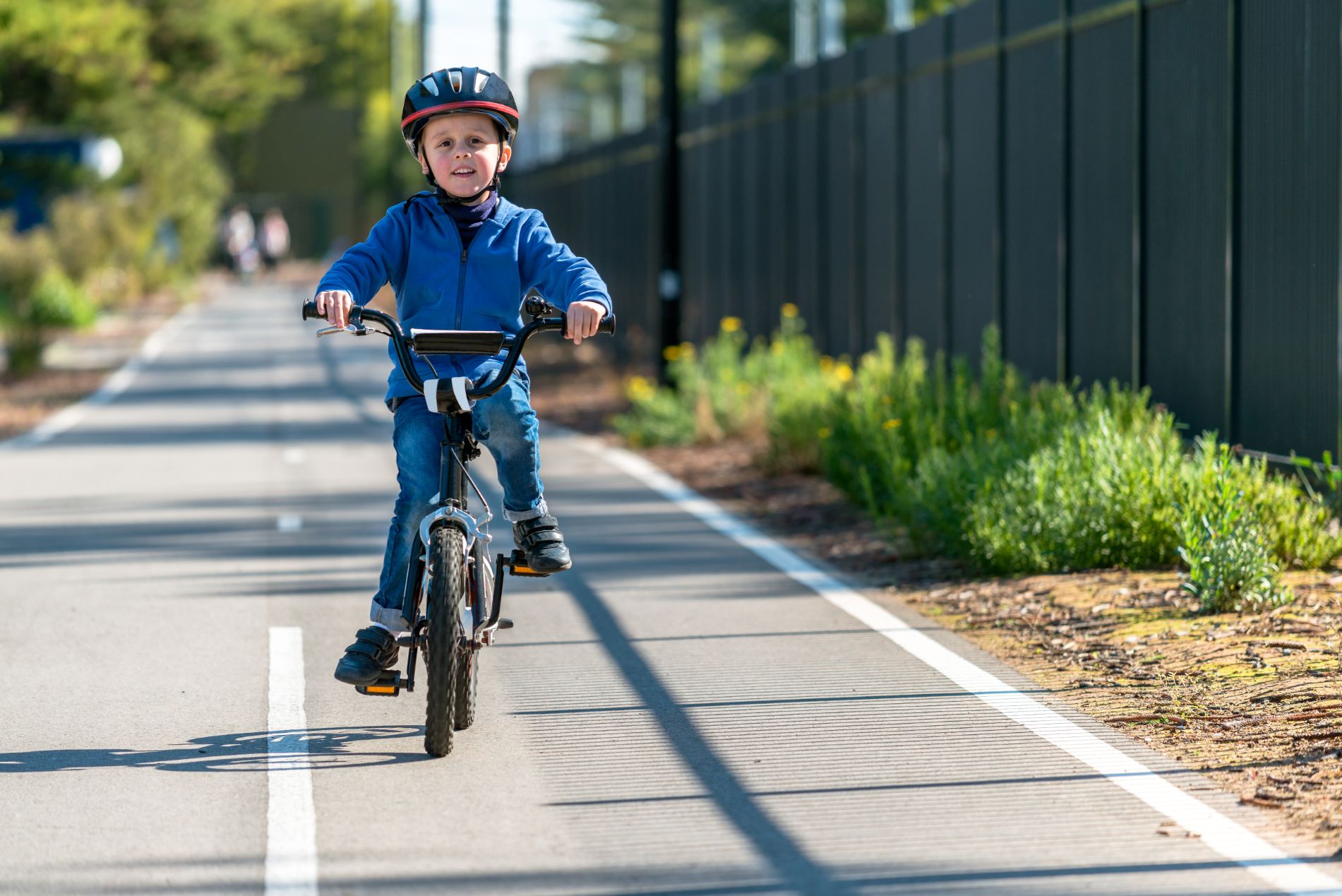 boy riding bike in bike lane