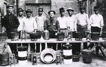 RatCatchers.jpg Rat Catchers in New Orleans; Group portrait of nine men standing behind a makeshift table