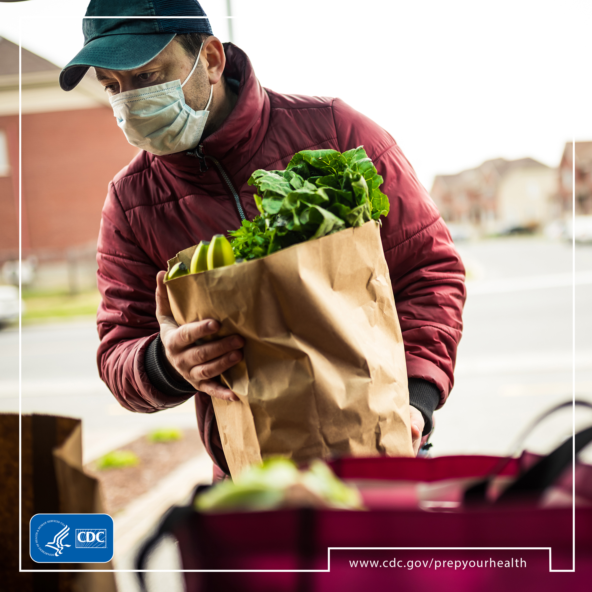 Man putting groceries in car
