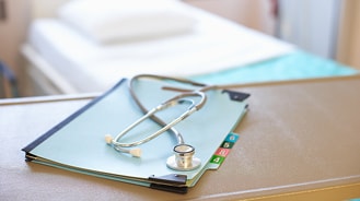 report_feature.jpg Stethoscope sitting on top of a stack of papers