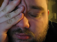 Man holds his head as if he has a bad headache