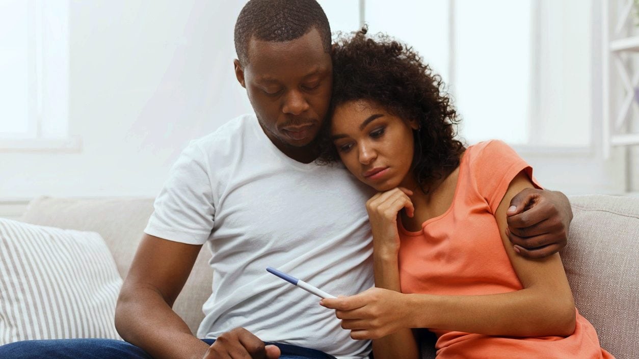 couple looking at pregnancy test results