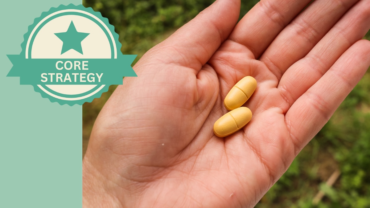 Treatment Two pill capsules resting in the palm of an adult hand.