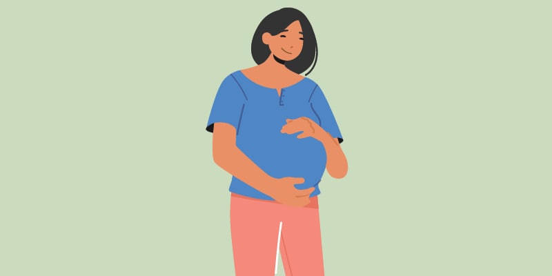 Pregnant woman cradling her belly.