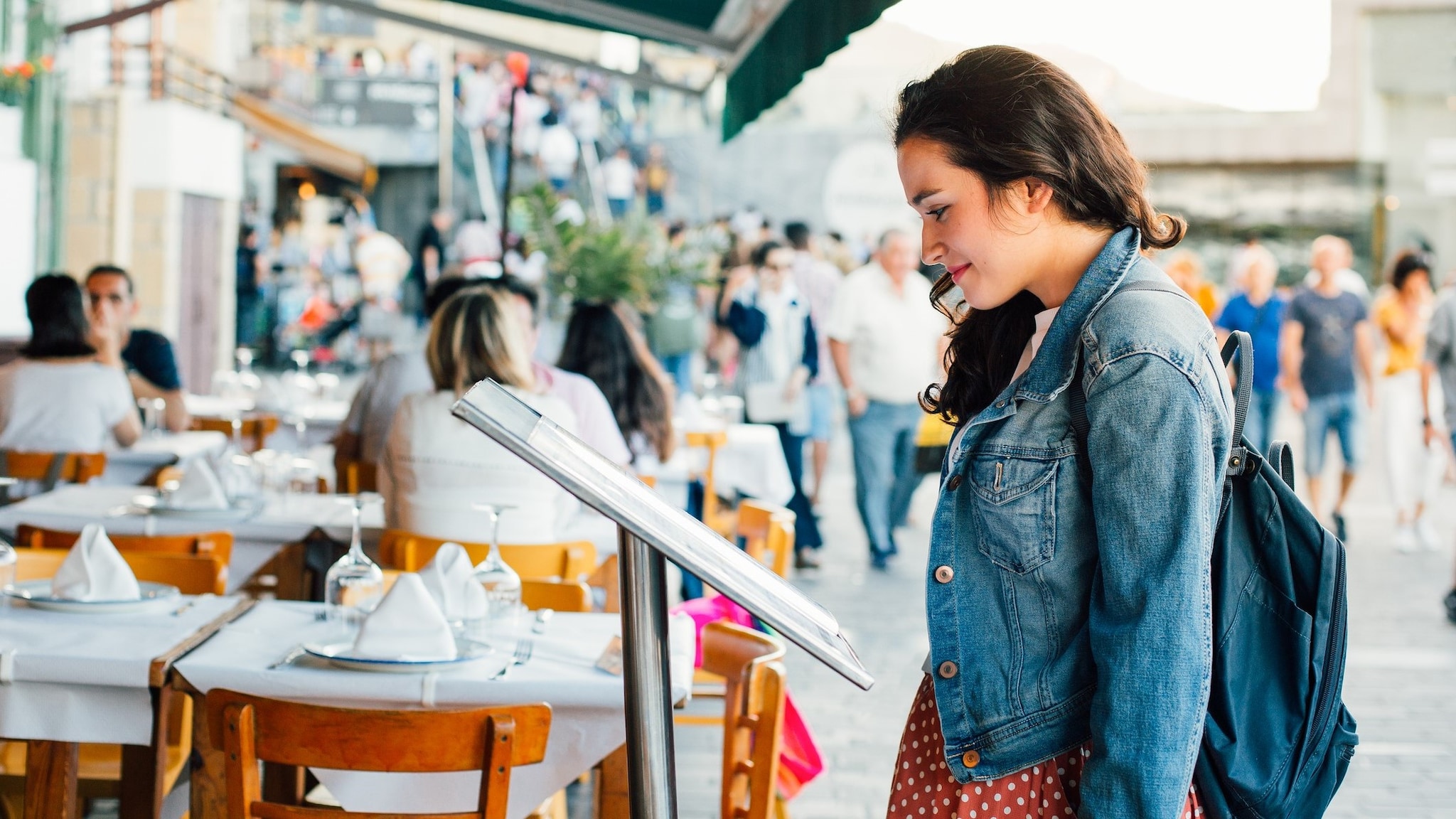 Tips for Dining Out Person looking at a menu outside a restaurant