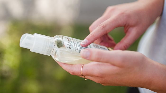 Close up view of a person reading label on insect repellent
