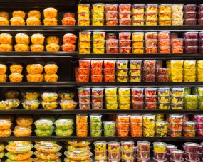 Pre-Cut Melon Fruit Display Photo of packages of pre-cut melon on shelves.