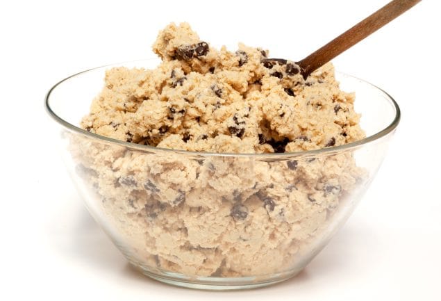 Bowl of cookie dough with a wooden spoon and chocolate chips Bowl of cookie dough with a wooden spoon and chocolate chips