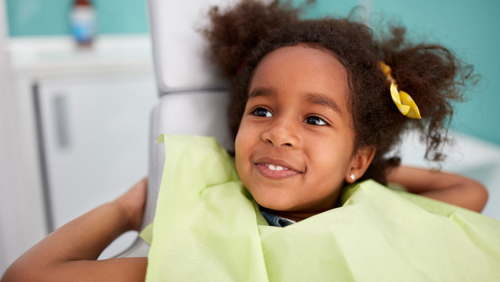 Smiling girl in dentist chair A young girl smiling in dentist chair.