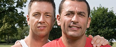 A man putting his hand on another man's shoulder.