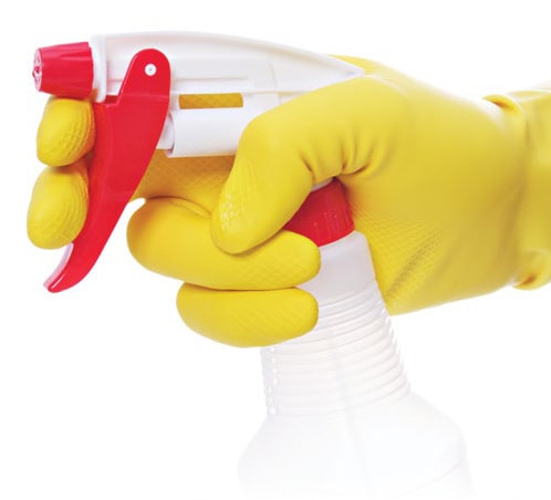 Using Bleach Safely gloved hand holding spray bottle containing bleach